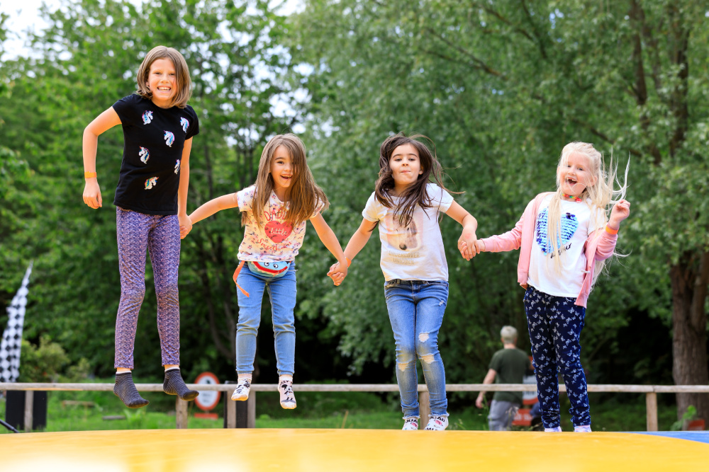 Kids bouncing on the outdoor pillows