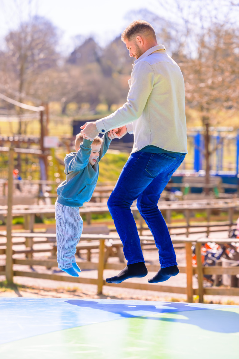 Dad and son playing on the jumping pillows