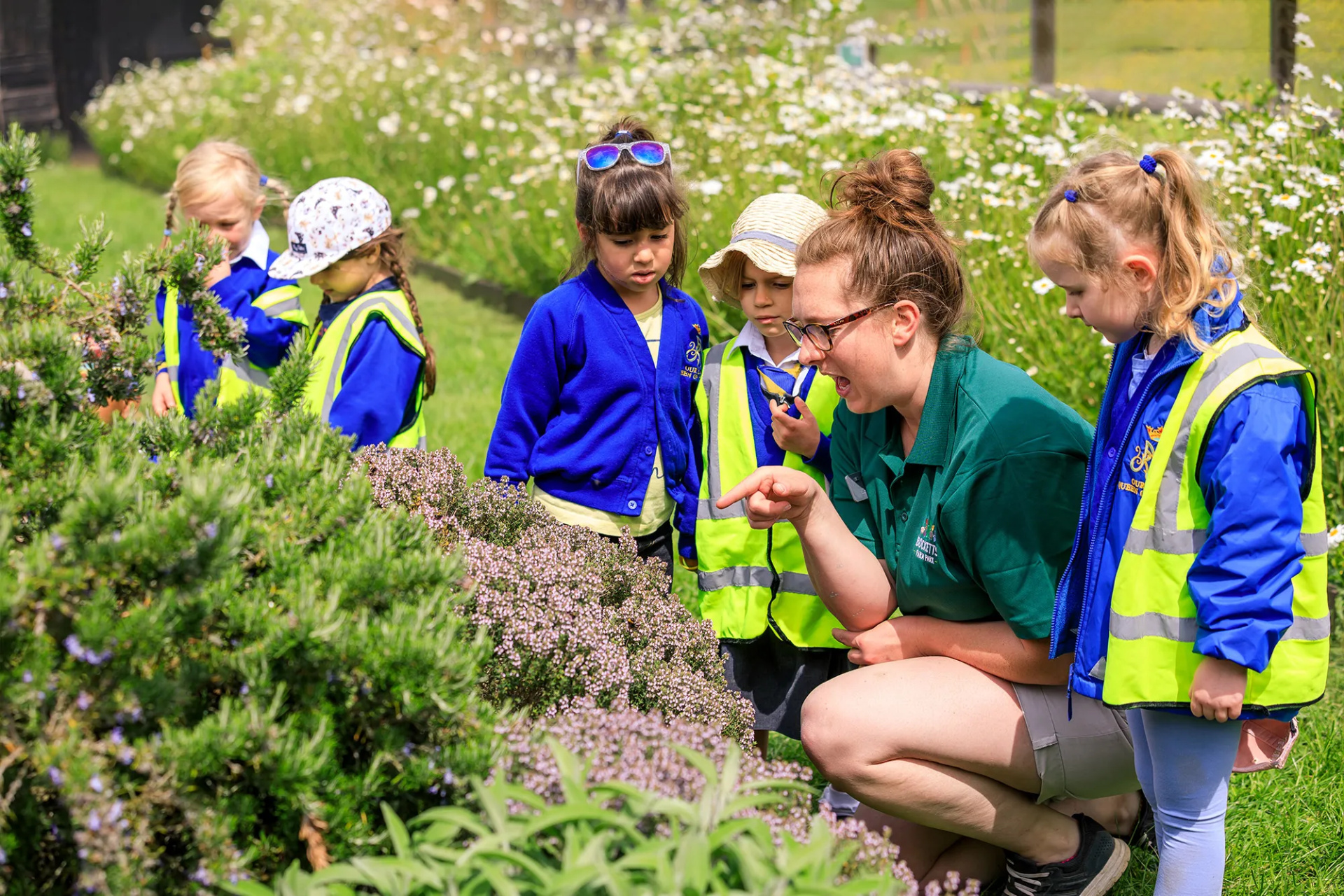Staff teaching school children in the garden
